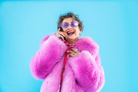 Photo for Happy and funny senior old woman wearing fashinable clothing on colorful background- Modern cool fancy grandmother portrait, concepts about elderly and older people - Royalty Free Image