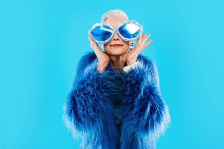 Photo for Happy and funny senior old woman wearing fashinable clothing on colorful background- Modern cool fancy grandmother portrait, concepts about elderly and older people - Royalty Free Image