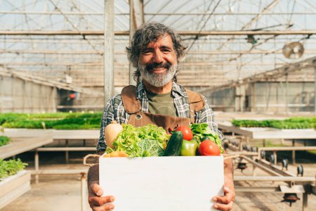 Photo for Farmer senior man working in his farm and greenhouse. Concept about agriculture, farn industry, and healthy lifestyle during seniority age - Royalty Free Image