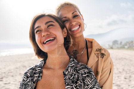 Photo for Beautiful multiethnic lesbian couple of lovers dating outdoors - LGBT people bonding and spending time together, concepts about LGBTQ community, diversity, love and lifestyle - Royalty Free Image