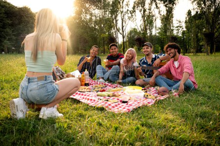 Photo for Group of multiethnic teenagers spending time outdoor on a picnic at the park. Concept about generation z, lifestyle and friendship - Royalty Free Image