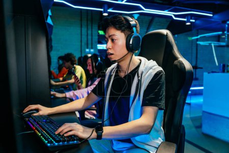 Photo for Multiethnic group of young friends playing videogames - Team of professional esport gamers playing in competitive video games on a cyber games tournament - Royalty Free Image
