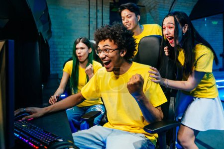 Photo for Multiethnic group of young friends playing videogames - Team of professional esport gamers playing in competitive video games on a cyber games tournament - Royalty Free Image
