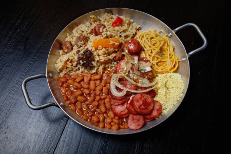 Photo for Rice with sausage and vegetables on a black background - Royalty Free Image