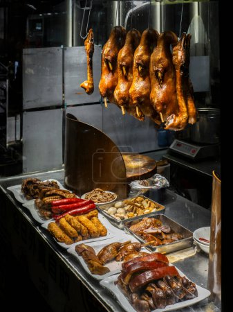 Photo for Roasted goose, heads and other type of meat hanging in a restaurant window in Hong Kong - Royalty Free Image