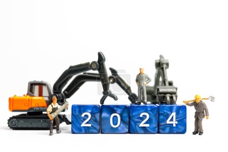 Photo for Miniature people , Worker team flips a block with the number 2024, On a white background - Royalty Free Image