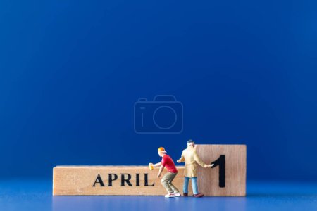 Photo for Miniature people painting a wooden block on April 1st, april fools day concept - Royalty Free Image