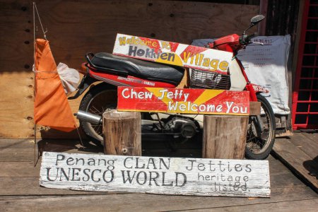 Photo for Georgetown, Penang, Malaysia - November 2012: Colourfully painted signboards at the UNESCO heritage listed Chew Jetty in the clan jetties of the city of George Town. - Royalty Free Image