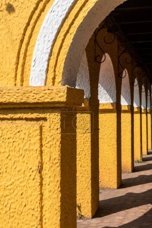 Photo for Detail of yellow arches of an old Portuguese era building in Fontainhas in the city of Panjim in Goa. - Royalty Free Image