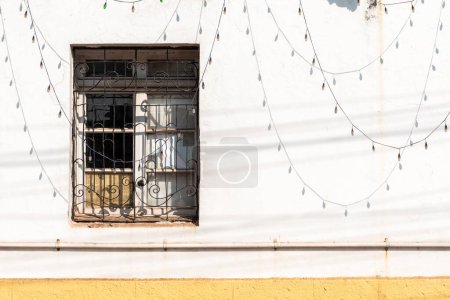 Photo for Panjim, Goa, India - January 2023: Window on the white wall of an old building with shadows of decorative LED lights. - Royalty Free Image