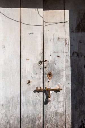 Photo for Panjim, Goa, India - January 2023: Detail of a vintage textured surface of a rustic door. - Royalty Free Image