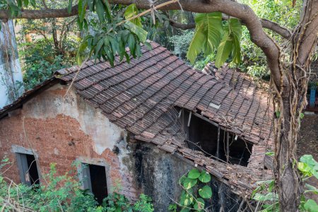 Photo for Panjim, Goa, India - January 2023: Top angle view of an old rustic dilapidated house with broken tiled roofs. - Royalty Free Image