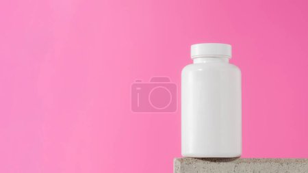 Photo for Mockup is a white jar with pills or vitamins on a podium on a pink background. The concept of medical preparations. Copy space - Royalty Free Image