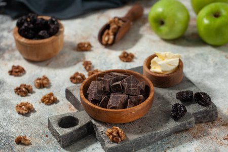 Cubes of dark artisan chocolate. Rich dark chocolate with walnuts and dried fruit, a tempting mix of textures and flavors