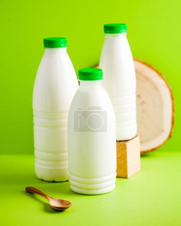 Triple set of dairy bottles with green caps, symbolizing freshness and health. Concept of Dairy product. Milk