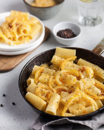 Delicious pasta with cheese sauce and lemon zest. The concept of Italian cuisine, the recipe.