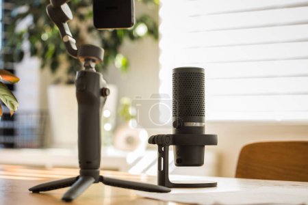 Podcast-Mikrofonaufbau auf einem Holztisch, warmes Licht. Das Konzept der Aufnahme eines Podcasts, Streamers
