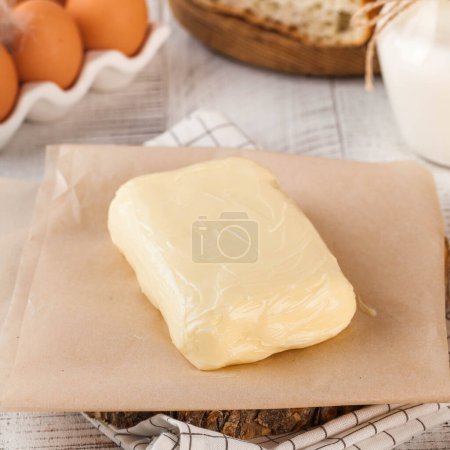 Freshly crafted creamy butter slab on parchment, ideal for cooking and rich breakfasts. Dairy