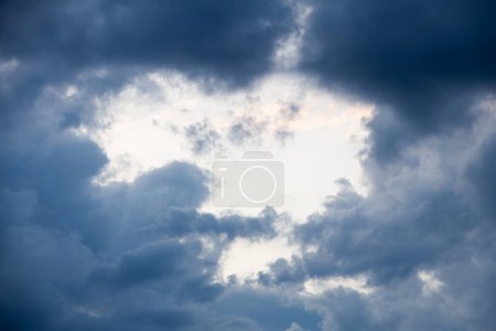 Photo for Hole in clouds - stormy weather background - Royalty Free Image