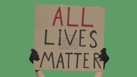 Photo for Hands of an unknown person in black gloves raise cardboard poster ALL LIVES MATTER. Stop Racism concept, No Racism. Rallies against racism and police brutality. Peaceful life of blacks matters - Royalty Free Image