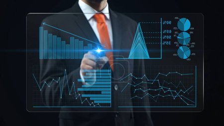 Businessman uses holographic interface, turns on touch screen and appears financial chart. Man in a black suit and red tie touches finger of stock market charts and diagrams on a holographic screen