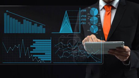 Holographic interface with touch screen and financial graph. Man in a black suit and red tie uses tablet and stock market charts and diagrams on holographic screen. Virtual display of the future
