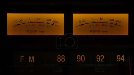 Photo for Yellow controls dashboard on an old analog radio. Close up of a scale with an arrow measuring signal power on vintage electronic sound audio device. Retro revival and nostalgia concept - Royalty Free Image