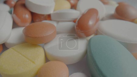 Photo for Medical tablets, pills and capsules close up. White, blue and brown, round and oval assorted medicines. Vitamins, antibiotics, painkillers. Concept of medicine, healthcare and disease treatment - Royalty Free Image