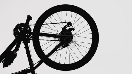 Photo for Black silhouette of a part of a modern sports bike on a white isolated background. Close up of a round bicycle wheel with nipple, spokes and brake. Part of a bicycle frame with pedals, chain - Royalty Free Image