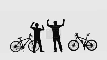 Foto de Black silhouettes of two cyclists raise their hands up and rejoice in the journey or victory on white background. Travelers bicyclists standing near their sports bikes. Full length shot. Active sporty - Imagen libre de derechos
