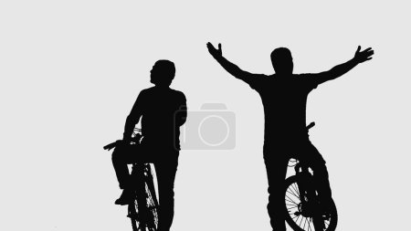 Téléchargez les photos : Black silhouettes of two male cyclists communicating on a white isolated background. Male athletes contemplating and admires the surroundings. Travelers bicyclists sitting on their sporty modern bikes - en image libre de droit