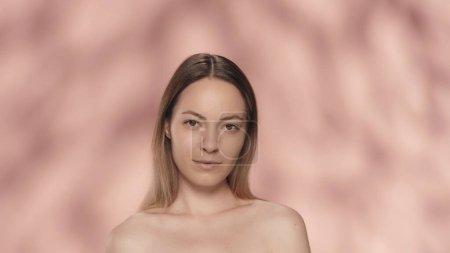 Photo for Portrait of a seminude woman on a pink background close up. A woman with natural makeup looks straight ahead. Beauty concept. Natural beauty, cosmetology, skin care - Royalty Free Image