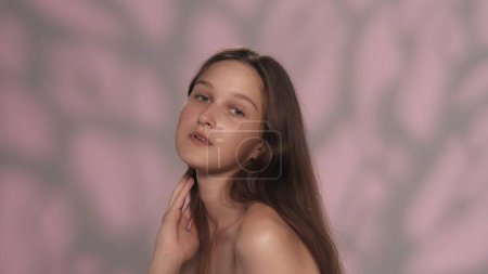 Photo for Portrait of beautiful young caucasian model. Close up shot of a pretty girl with fresh skin, long hair and natural makeup looking at the camera. Beauty skincare advertisement concept. - Royalty Free Image