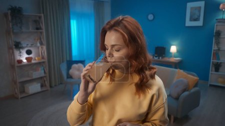 Photo for Young woman drinks medicine from a glass close up. Cure for a cold, pain or hangover. Home medicine concept - Royalty Free Image