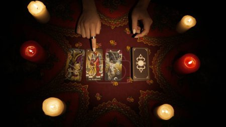 Photo for Fortune teller session scene, top view. Close up shot of a female hand pointing on a layout of tarot cards. Woman explaining the meaning of divination. Esoteric concept. - Royalty Free Image