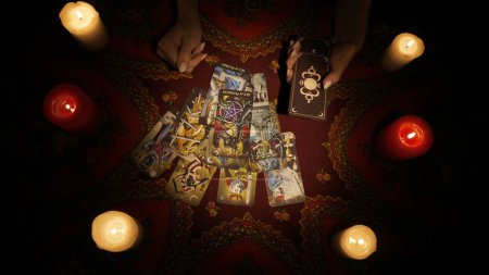 Photo for Fortune teller session scene. Close up shot of a female hands holding a deck and making a big fan layout with tarot cards for her client. Esoteric concept. - Royalty Free Image