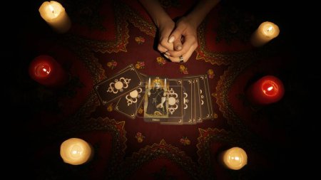 Photo for Fortune teller session scene. Close up shot of a female hands placing a fan of tarot cards on the table and showing it to the camera. Divination concept. - Royalty Free Image