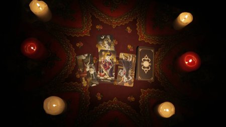Photo for Fortune teller session scene. Close up shot of the table with big open layout of tarot cards made for client, images of cards are visible to the camera. Divination concept. - Royalty Free Image