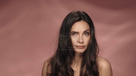 Photo for Portrait of a seminude disappointed woman on a pink background close up. Beauty concept. Natural beauty, cosmetology, skin care - Royalty Free Image