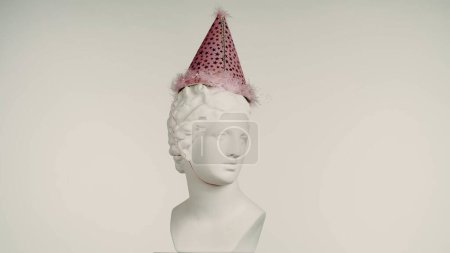Photo for Closeup shot of beautiful ancient goddess Venus marble statue in party hat. Portrait of roman era female bust rotating on a platform. Isolated on white background. Creative abstract concept. - Royalty Free Image