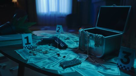 Photo for Crime scene creative concept. Closeup shot of the table in the apartment with signs of hacks and robbery. Illegal criminal objects on the table gun, money. Police flashlights behind the window. - Royalty Free Image