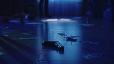 Photo for Crime scene creative concept. Closeup shot of the floor with illegal criminal objects in the dark apartment room with blue light. Money, blood traces, gun and jewellery laying on it. Police officer in - Royalty Free Image