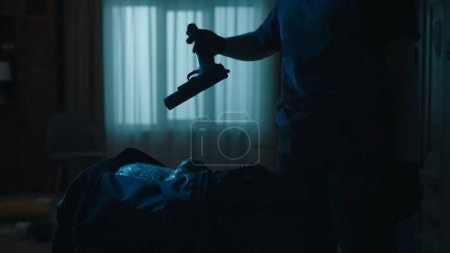 Photo for Crime scene creative concept. Closeup shot of black sport bag. Police woman takes out the handgun. Portrait of woman in uniform holding gun in hand. - Royalty Free Image