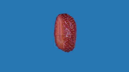 Photo for Healthy eating fruits and vegetables creative concept. Berry against colored screen. Closeup studio shot of round slice of strawberry isolated on blue background. - Royalty Free Image