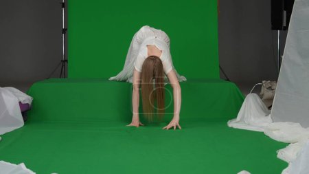 Photo for Full-size green screen shot of a posessed female, woman figure, ghost, poltergeist, zombie crawling over an obstacle towards the camera. The ring reference. Horror clip, advertisement, walking dead - Royalty Free Image