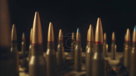 Photo for Rows of numerous rifle cartridges on a black background close up. The concept of firearms, shooting range, production and trade of ammunition - Royalty Free Image