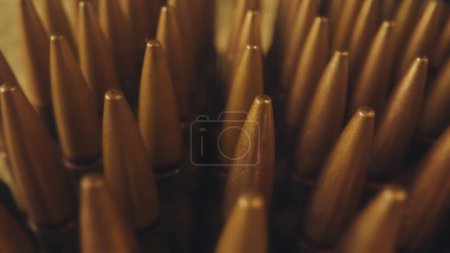 Photo for Rows of numerous rifle cartridges close up. The concept of firearms, shooting range, production and trade of ammunition - Royalty Free Image