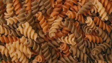 Photo for Closeup shot of many colorful pasta spirals background. Advertising area, template. Space to insert advertisement object. Creative abstract concept. - Royalty Free Image