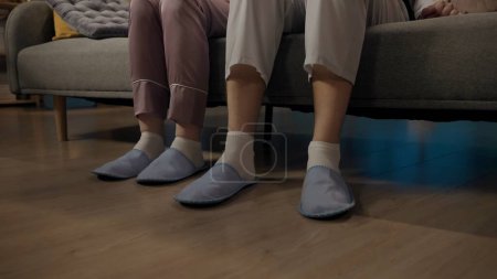 Photo for Beauty and healthy relationships advertisement concept. Portrait of young couple spending time together. Closeup shot of man and woman sitting on the sofa in pajamas and slippers. - Royalty Free Image