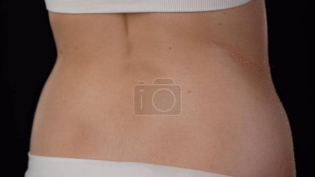 Photo for Skin texture and bodycare healthcare concept. Portrait of young female model. Closeup studio shot of beautiful caucasian woman in underwear, body part back and waist hips area soft skin in water drops - Royalty Free Image